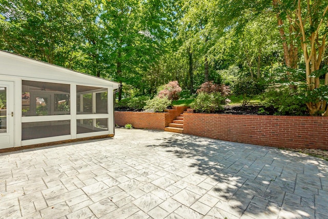 view of patio featuring a sunroom