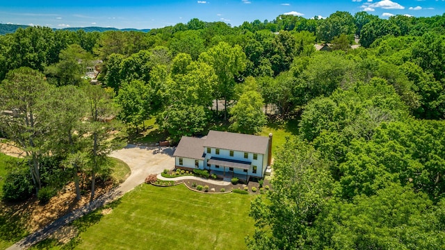 birds eye view of property with a view of trees