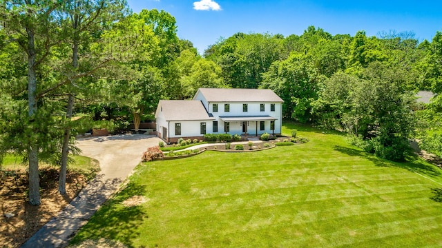 view of front of home featuring covered porch, concrete driveway, and a front yard