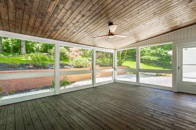 unfurnished sunroom featuring lofted ceiling, wooden ceiling, and a ceiling fan