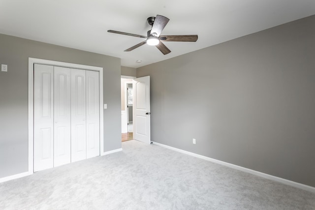 unfurnished bedroom featuring a ceiling fan, a closet, baseboards, and carpet flooring