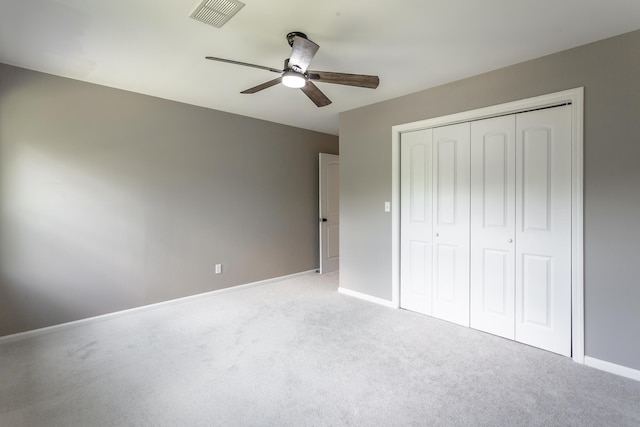 unfurnished bedroom with baseboards, visible vents, a closet, and light colored carpet