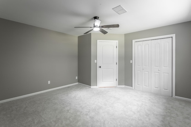 unfurnished bedroom featuring carpet floors, a closet, visible vents, and baseboards