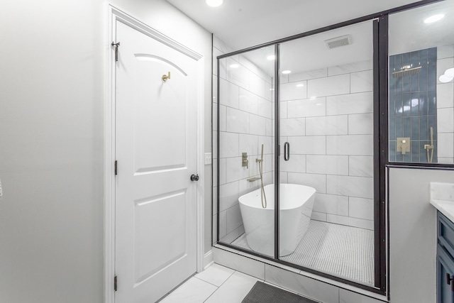 full bathroom with a soaking tub, visible vents, a shower stall, vanity, and tile patterned floors