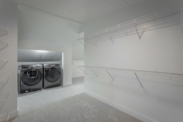 walk in closet featuring lofted ceiling, carpet flooring, and washer and dryer