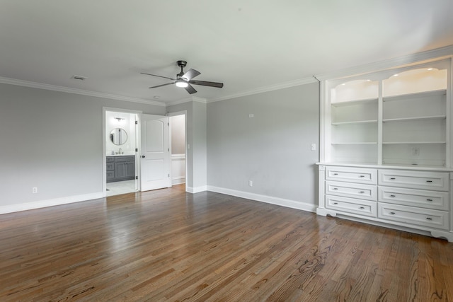 unfurnished bedroom featuring baseboards, dark wood finished floors, visible vents, and crown molding