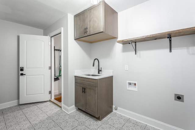 laundry room with washer hookup, cabinet space, hookup for an electric dryer, a sink, and baseboards