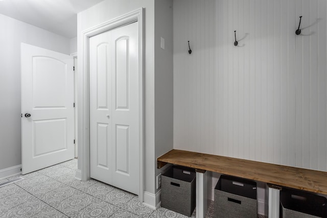 mudroom with baseboards and light tile patterned flooring