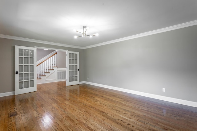 spare room with ornamental molding, french doors, and wood finished floors