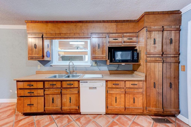 kitchen featuring white dishwasher, black microwave, brown cabinets, and a sink