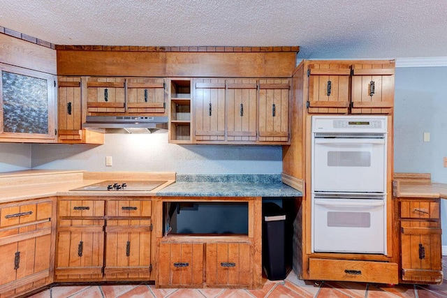 kitchen featuring brown cabinets, black electric stovetop, double oven, a textured ceiling, and under cabinet range hood