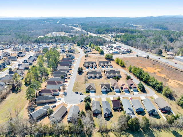 bird's eye view with a residential view and a wooded view