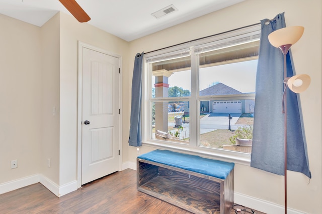 sitting room featuring a healthy amount of sunlight, visible vents, and wood finished floors