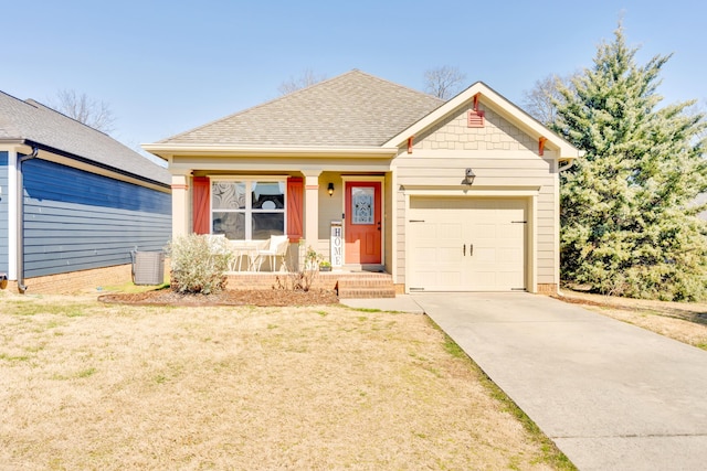 view of front facade with a shingled roof, concrete driveway, an attached garage, a porch, and a front yard