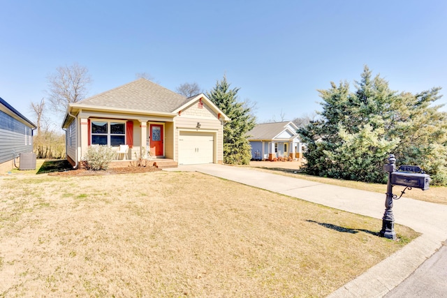 view of front of property featuring roof with shingles, concrete driveway, central AC unit, a front yard, and a garage