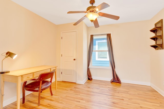 office area featuring ceiling fan, light wood-type flooring, and baseboards