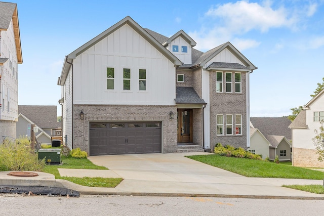 view of front of home featuring central AC unit, concrete driveway, an attached garage, board and batten siding, and brick siding