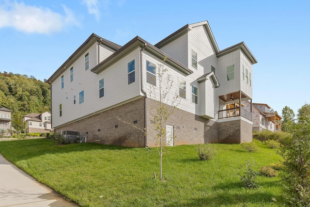 view of property exterior with a yard and brick siding