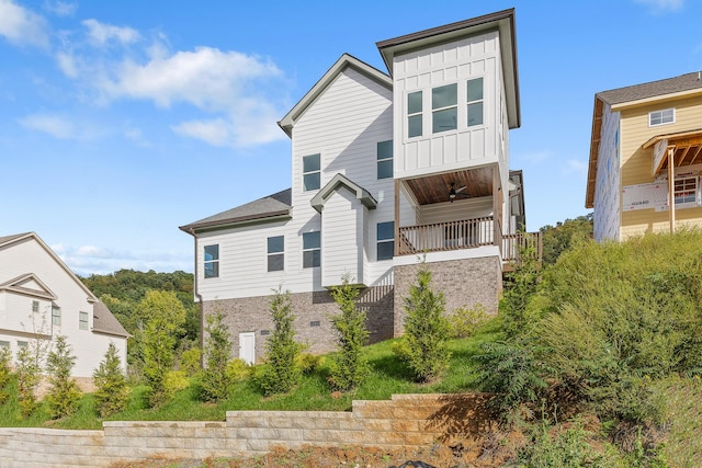 view of front of property featuring stairs, a ceiling fan, a porch, and board and batten siding