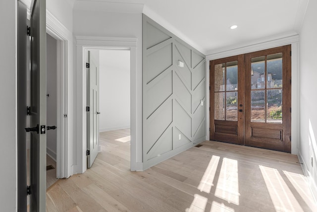 foyer featuring french doors, light wood-style flooring, and recessed lighting