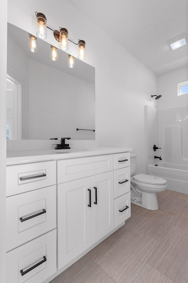 bathroom with bathtub / shower combination, vanity, toilet, and wood finished floors