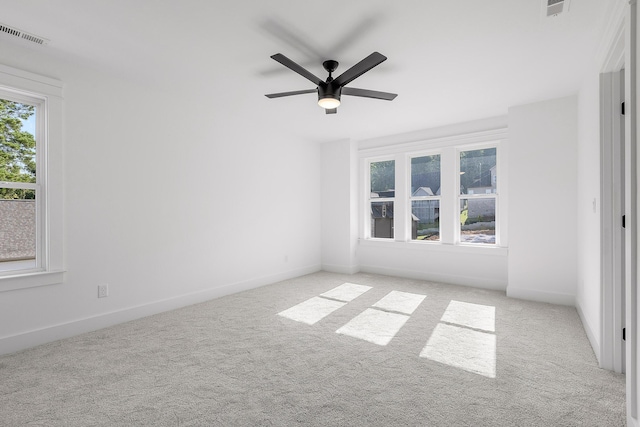 unfurnished room featuring a ceiling fan, baseboards, visible vents, and carpet flooring