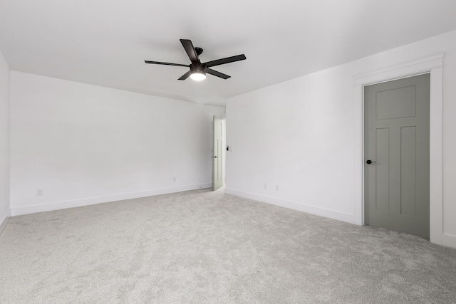 spare room with carpet floors, baseboards, and a ceiling fan