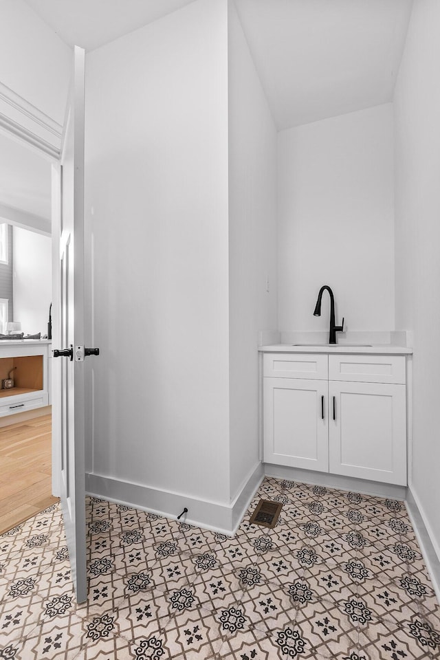 bathroom featuring baseboards and vanity