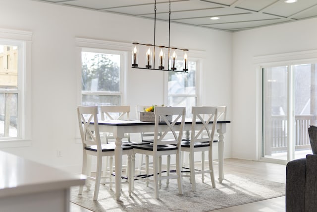 dining area with an inviting chandelier and wood finished floors