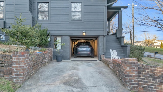 view of side of property featuring a garage and driveway