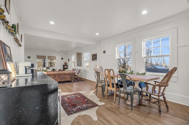 dining space featuring baseboards, wood finished floors, and recessed lighting