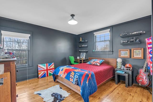 bedroom featuring hardwood / wood-style flooring and multiple windows