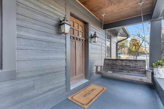 view of exterior entry featuring a porch