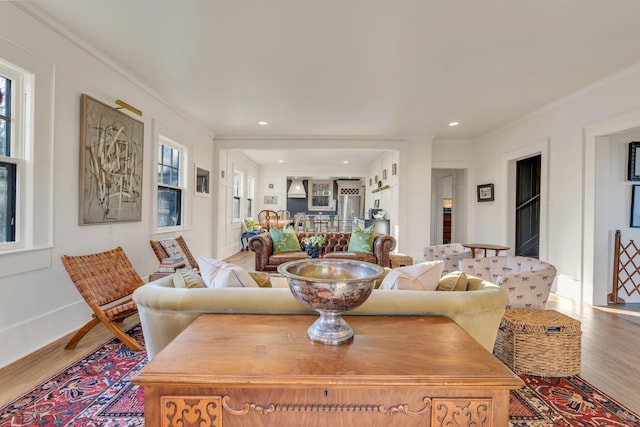 living room with recessed lighting, crown molding, baseboards, and wood finished floors