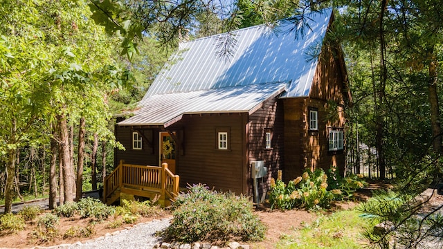 rustic home with metal roof and a chimney