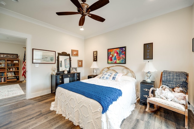 bedroom with ornamental molding, ceiling fan, baseboards, and wood finished floors