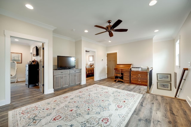 bedroom with crown molding, wood finished floors, and recessed lighting