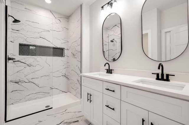 full bath with double vanity, marble finish floor, a marble finish shower, and a sink