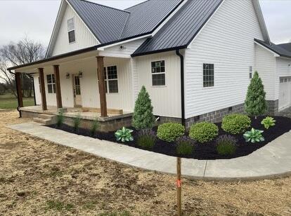 view of front of home with a porch, a standing seam roof, and metal roof