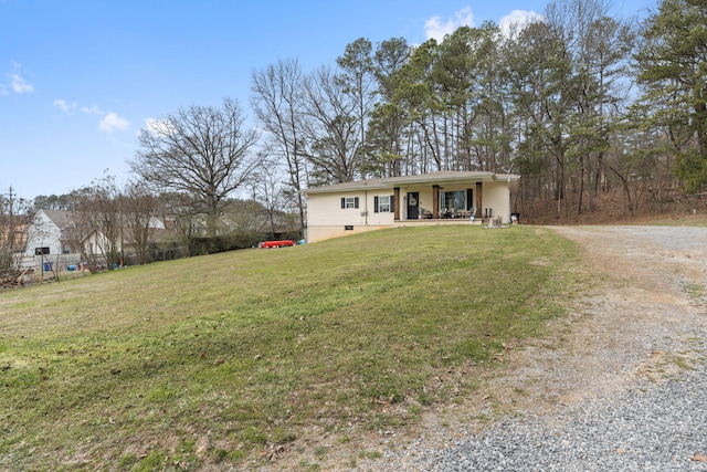 ranch-style home featuring a porch, a front yard, and driveway