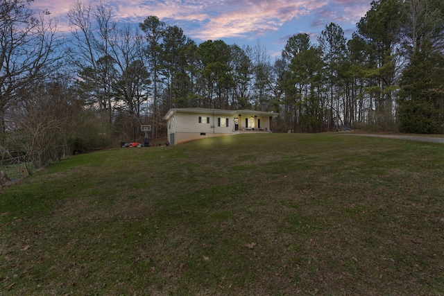 view of front of house with a front lawn, crawl space, and fence