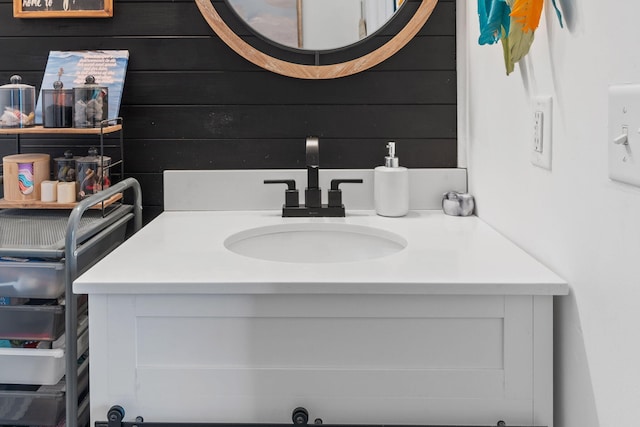 bathroom with wooden walls and vanity