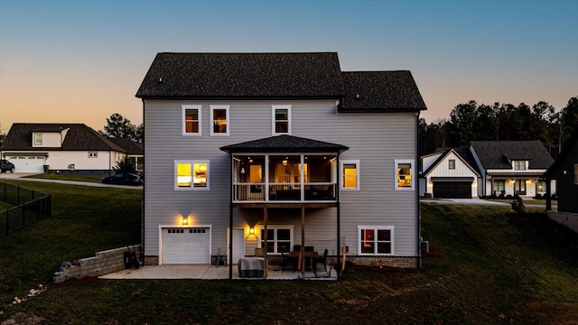 back of house with a patio, fence, a sunroom, a garage, and a lawn