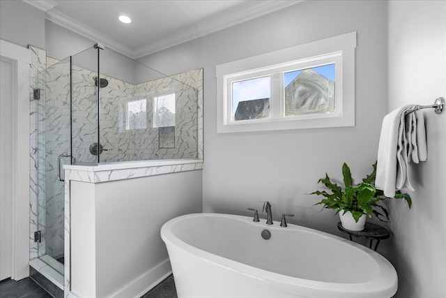 full bath featuring recessed lighting, a freestanding tub, a stall shower, and ornamental molding