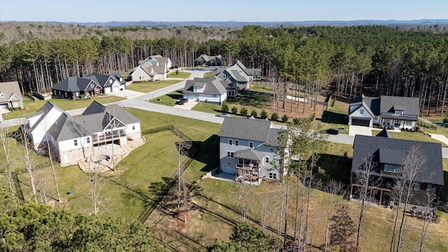 aerial view featuring a wooded view and a residential view