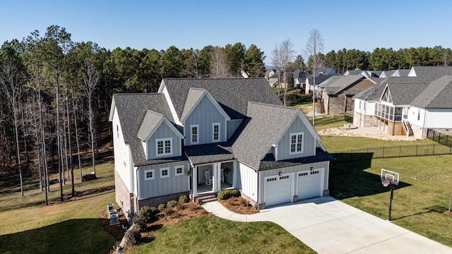 modern inspired farmhouse featuring board and batten siding, concrete driveway, and a front yard
