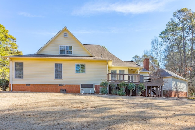 rear view of property with a yard and a deck