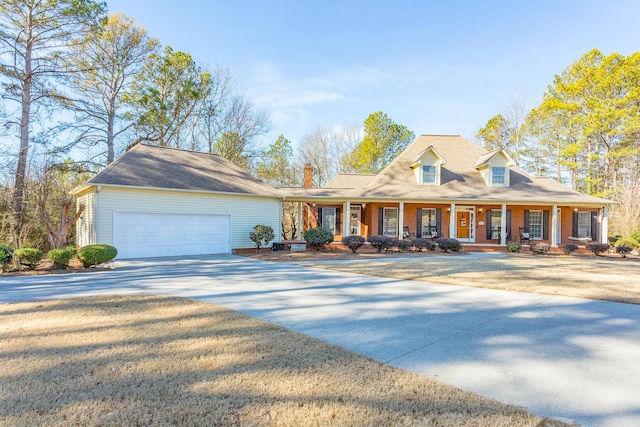 view of front of house featuring covered porch, driveway, and an attached garage