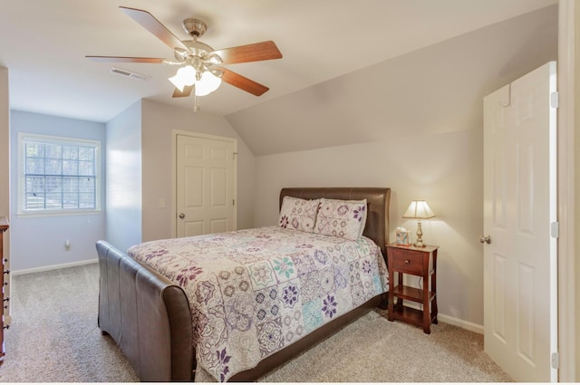 carpeted bedroom with ceiling fan, baseboards, visible vents, and vaulted ceiling