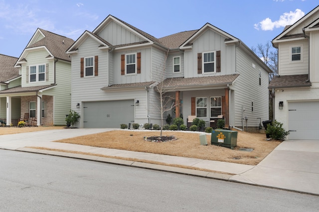 craftsman-style home featuring driveway, an attached garage, board and batten siding, and roof with shingles